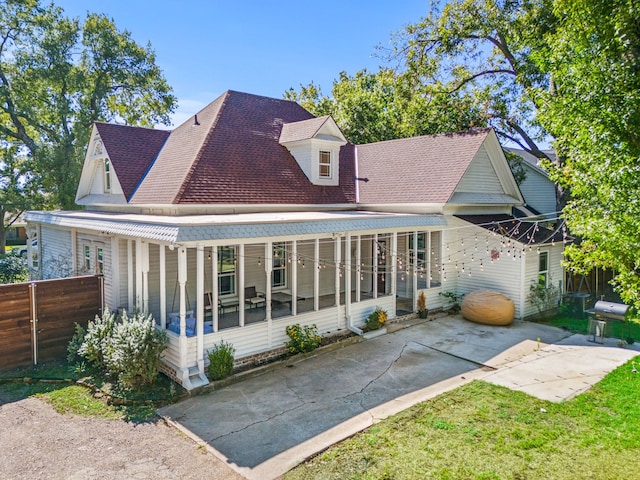 back of property featuring a sunroom and a patio area