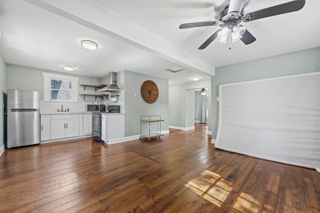 unfurnished living room featuring ceiling fan, dark hardwood / wood-style floors, and sink