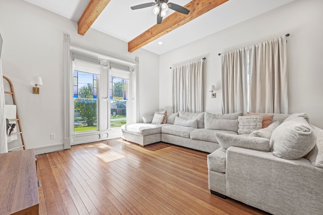 living room with wood-type flooring, beam ceiling, and ceiling fan