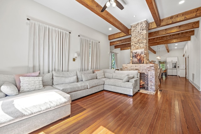 living room featuring beam ceiling, ceiling fan, hardwood / wood-style flooring, and a fireplace