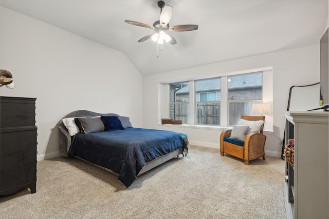 bedroom with vaulted ceiling, light colored carpet, and ceiling fan