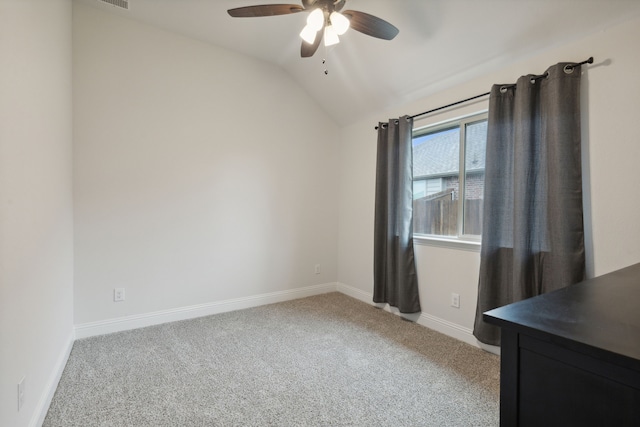 empty room featuring light carpet, lofted ceiling, and ceiling fan