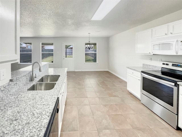 kitchen with white cabinets, appliances with stainless steel finishes, a wealth of natural light, and sink