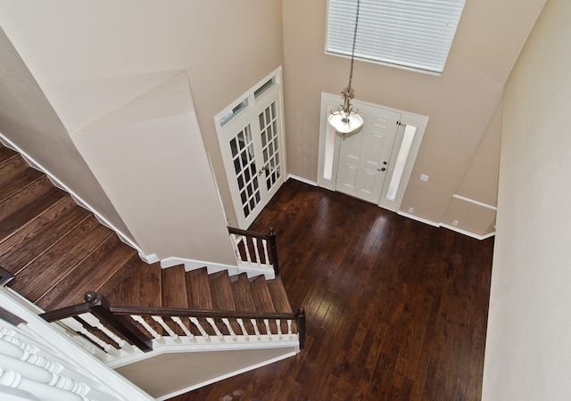 staircase with lofted ceiling and hardwood / wood-style flooring