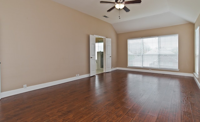 empty room with dark wood-type flooring, vaulted ceiling, and ceiling fan