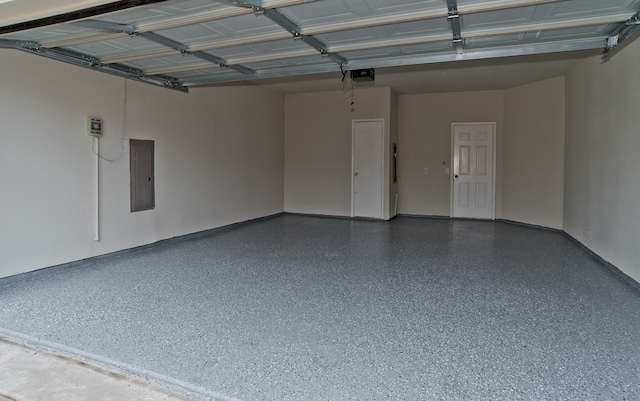 garage with electric panel and a garage door opener