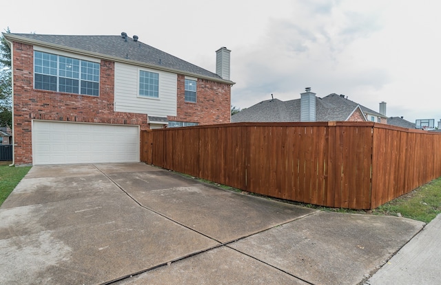 view of side of home featuring a garage