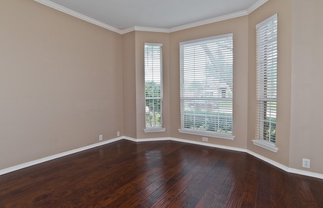 empty room featuring ornamental molding and dark wood-type flooring