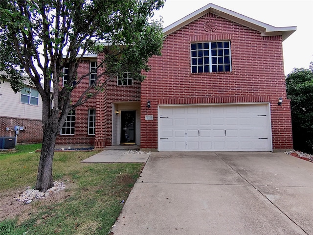 view of front of home with a garage, a front lawn, and central AC