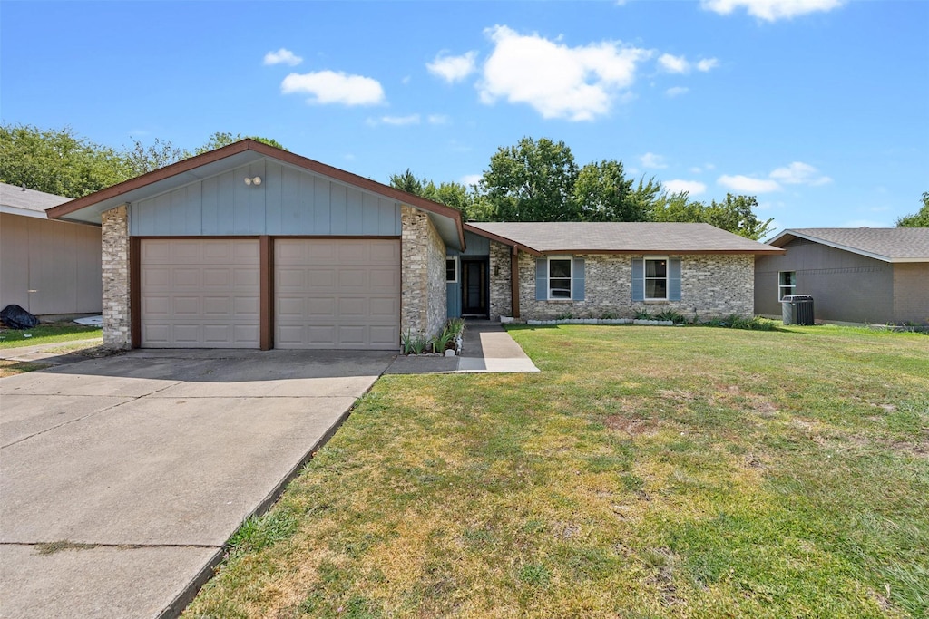 ranch-style home with a front lawn and a garage