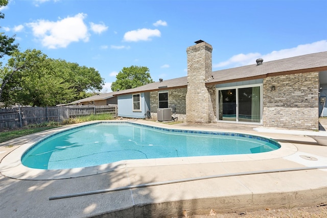 view of pool with central AC unit and a patio area