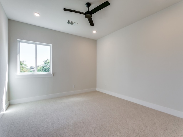 carpeted spare room with ceiling fan