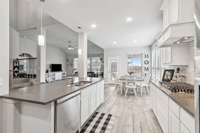 kitchen with pendant lighting, sink, ceiling fan, appliances with stainless steel finishes, and white cabinets