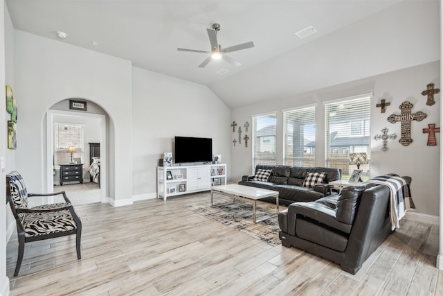 living room with high vaulted ceiling, ceiling fan, and light hardwood / wood-style floors