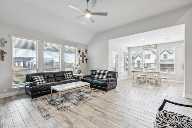 living room with light wood-type flooring, ceiling fan, and vaulted ceiling