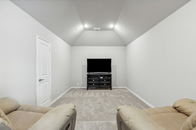 living room featuring lofted ceiling and carpet floors