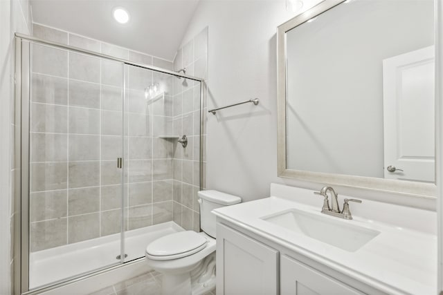 bathroom featuring vanity, toilet, vaulted ceiling, and a shower with shower door