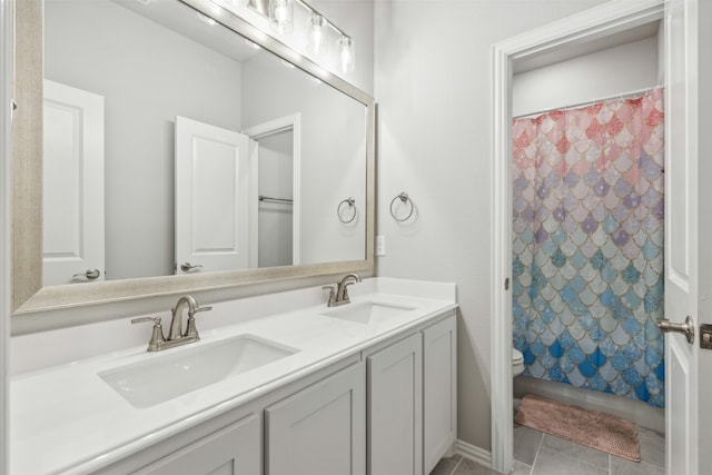 bathroom with vanity, toilet, and tile patterned floors