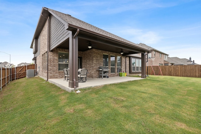 back of property with central AC, ceiling fan, a lawn, and a patio