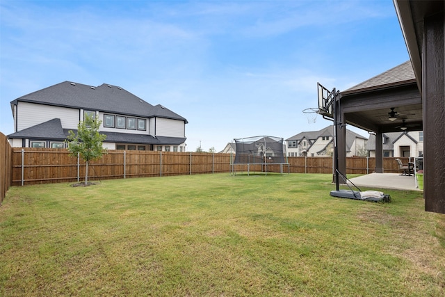 view of yard with a patio area, ceiling fan, and a trampoline