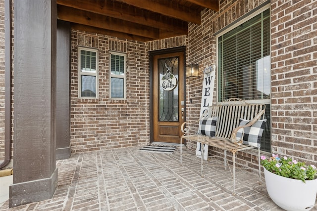 view of exterior entry with covered porch