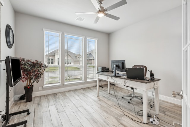 office space featuring a wealth of natural light, light hardwood / wood-style flooring, and ceiling fan