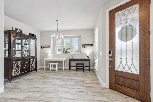 dining area featuring light hardwood / wood-style flooring and an inviting chandelier