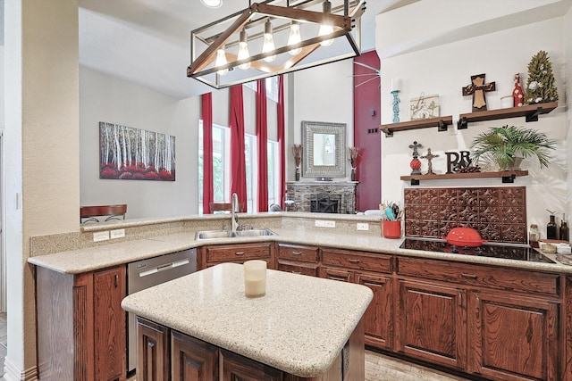 kitchen with light stone countertops, sink, black electric cooktop, kitchen peninsula, and stainless steel dishwasher