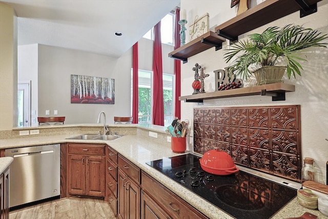 kitchen featuring light hardwood / wood-style flooring, light stone counters, sink, black electric stovetop, and stainless steel dishwasher