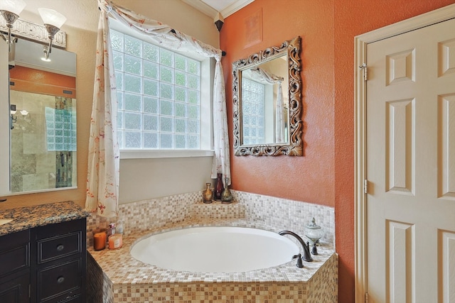 bathroom featuring ornamental molding, vanity, and a relaxing tiled tub