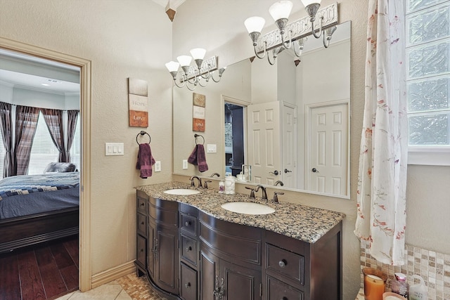 bathroom with crown molding, vanity, and hardwood / wood-style flooring