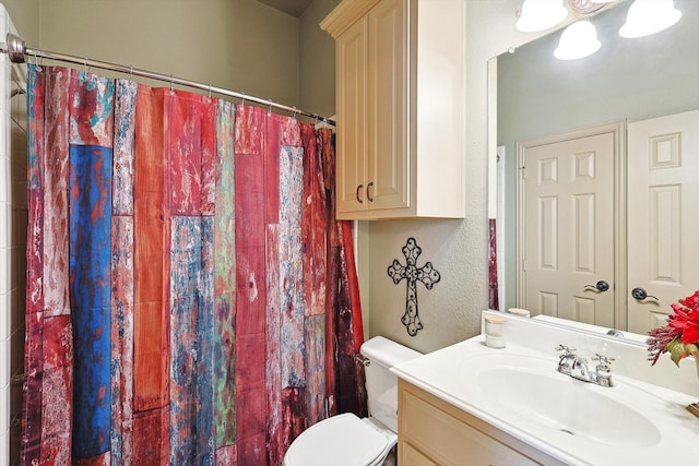 bathroom featuring a shower with curtain, toilet, and vanity