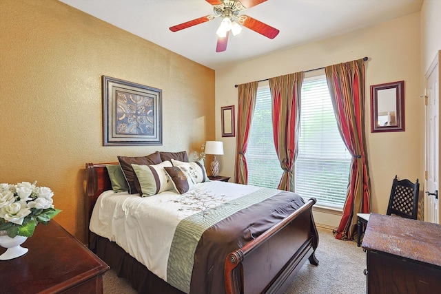 bedroom with ceiling fan and carpet floors