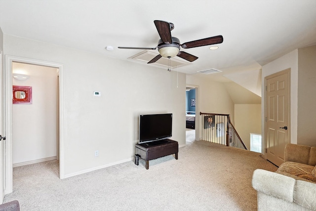 living room featuring carpet flooring, ceiling fan, and vaulted ceiling