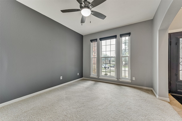 empty room featuring light carpet and ceiling fan