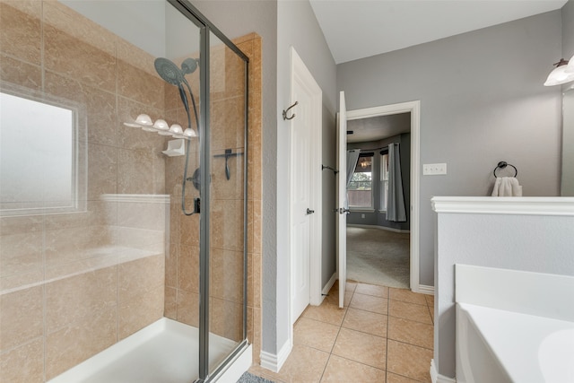 bathroom with tile patterned flooring and independent shower and bath