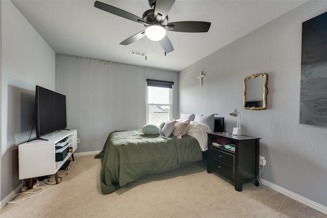 bedroom with a textured ceiling, ceiling fan, and carpet floors