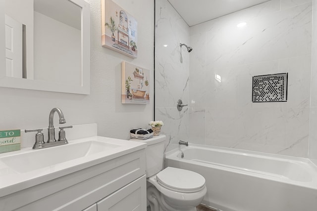 full bathroom featuring toilet, tiled shower / bath combo, and vanity