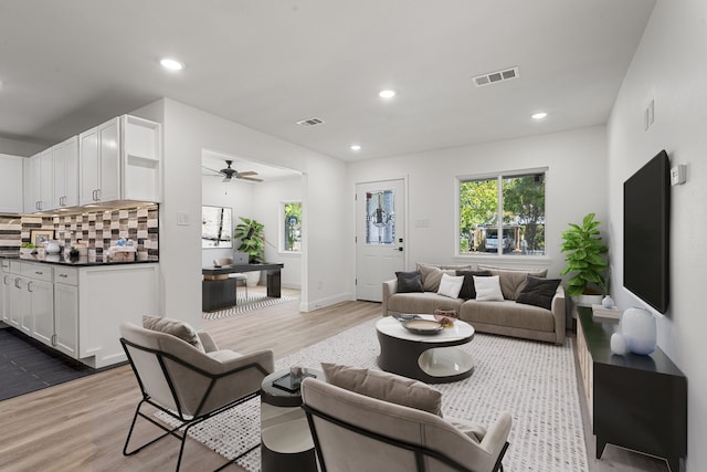 living room with ceiling fan and hardwood / wood-style flooring