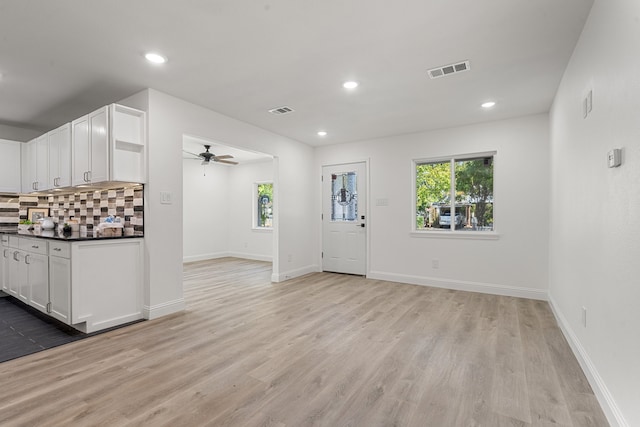 interior space with ceiling fan and light hardwood / wood-style flooring