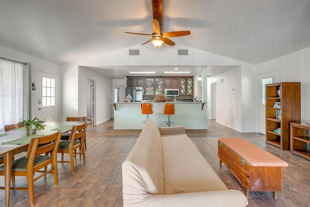 living room featuring ceiling fan and vaulted ceiling