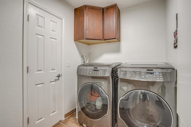 clothes washing area featuring separate washer and dryer and cabinets