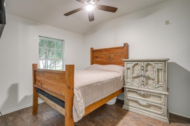 bedroom with ceiling fan, dark hardwood / wood-style floors, and lofted ceiling