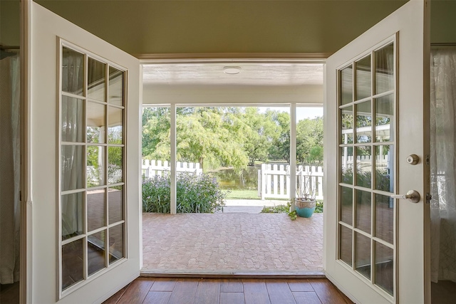 doorway with hardwood / wood-style floors, french doors, and a healthy amount of sunlight