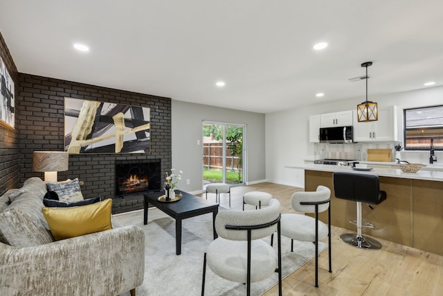 living room featuring a fireplace and light hardwood / wood-style floors