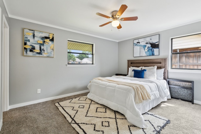 carpeted bedroom featuring crown molding and ceiling fan