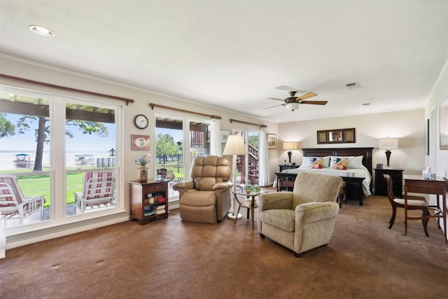 carpeted bedroom featuring ceiling fan and crown molding