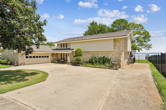 view of front of property featuring a front lawn and a garage