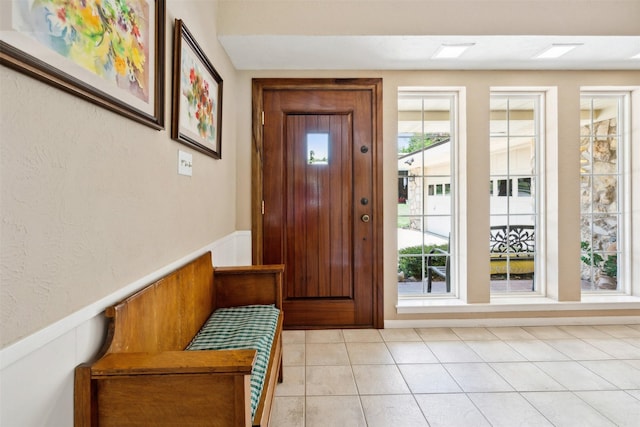 doorway to outside featuring a wealth of natural light and light tile patterned floors