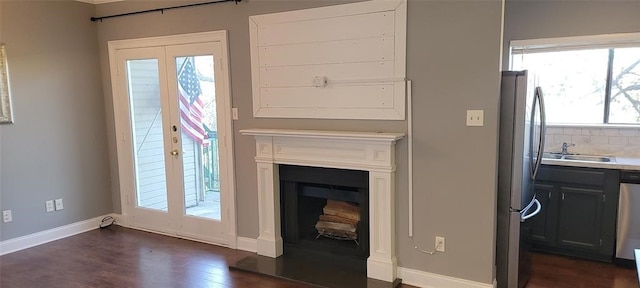 living room featuring sink, dark hardwood / wood-style flooring, and french doors